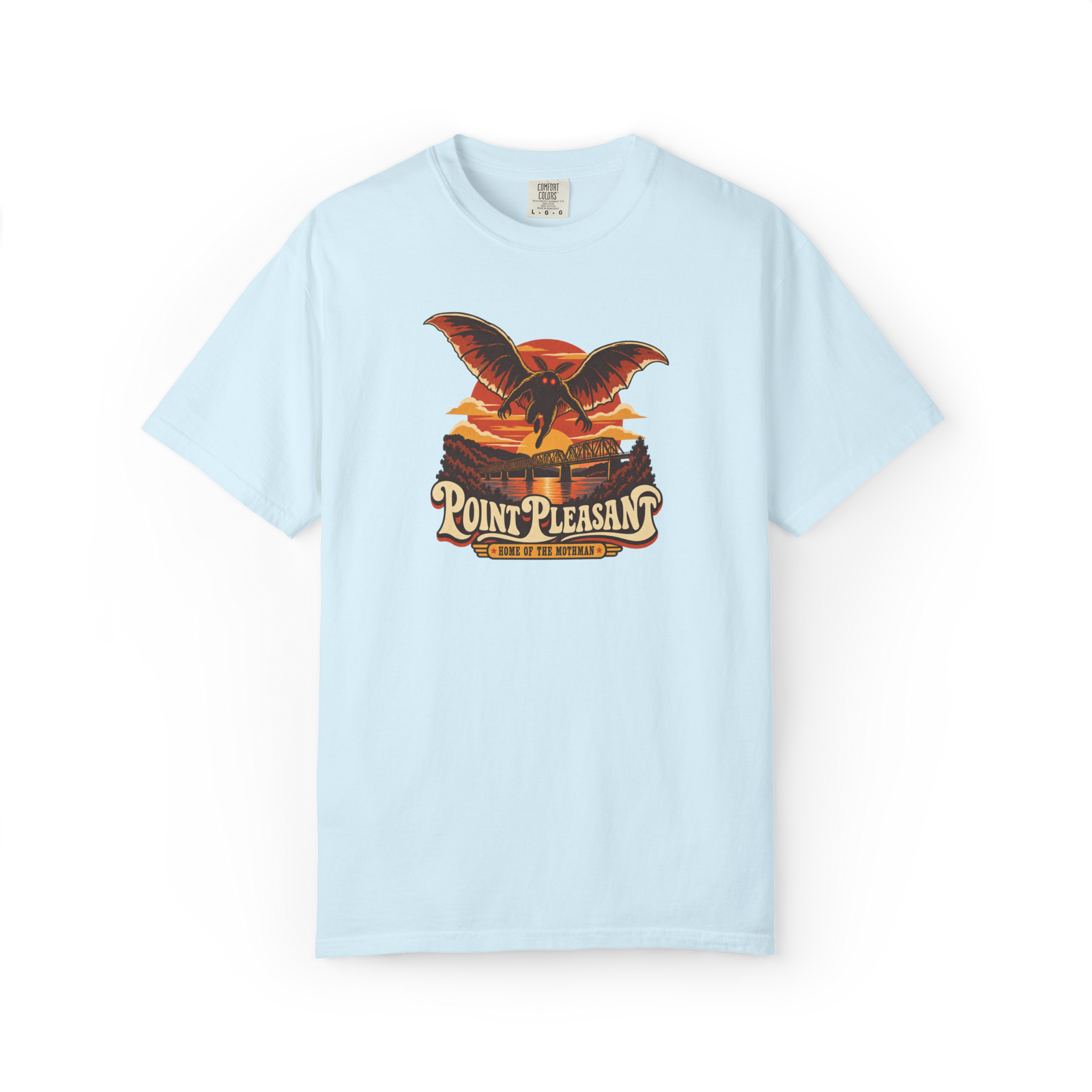 Light blue Mothman t shirt with retro sunset graphic, red-eyed Mothman flying above a bridge, and Point Pleasant Home of the Mothman text