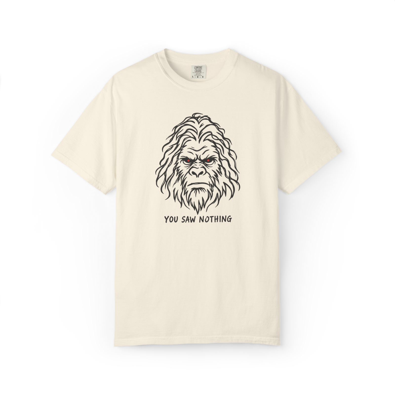 Ivory Bigfoot t shirt featuring a black Sasquatch face with glowing red eyes and You Saw Nothing text underneath