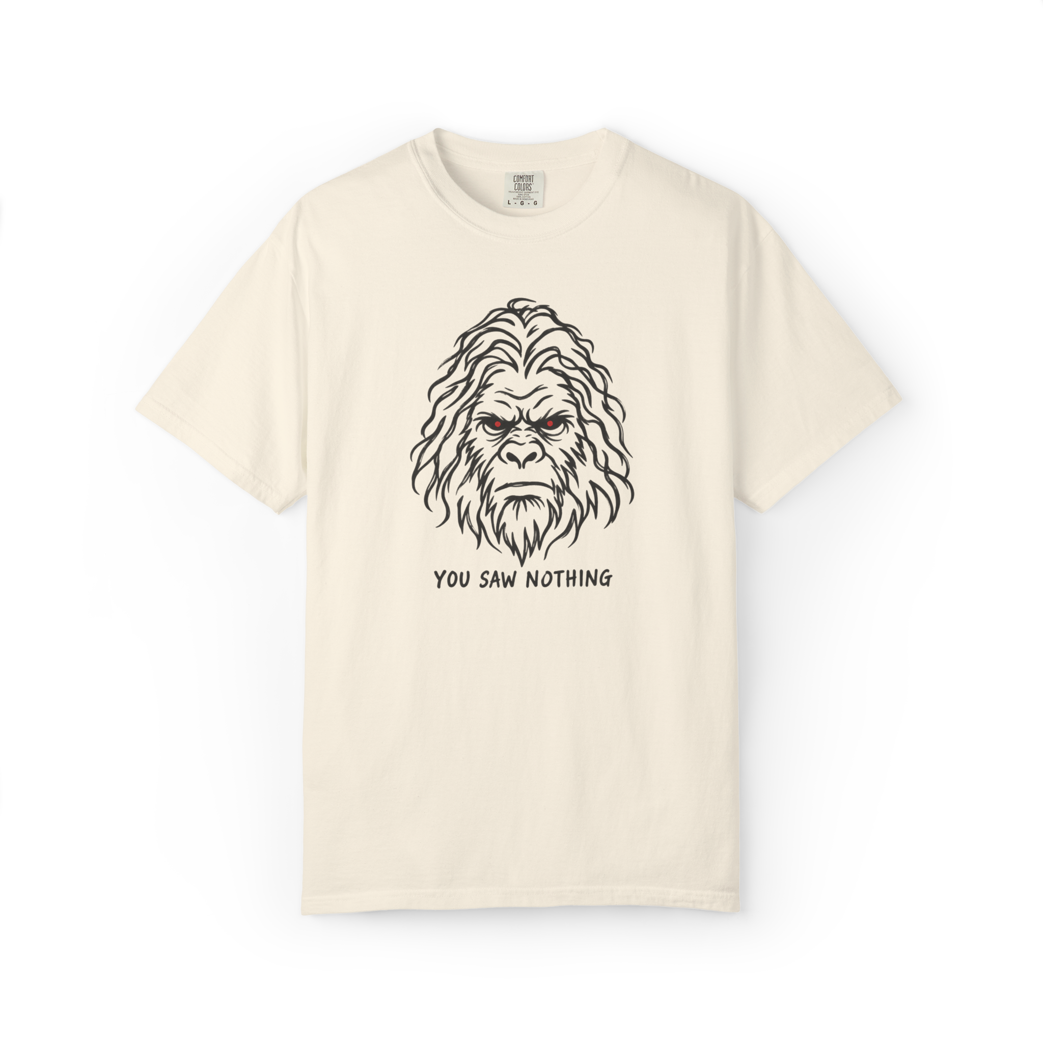 Ivory Bigfoot t shirt featuring a black Sasquatch face with glowing red eyes and You Saw Nothing text underneath