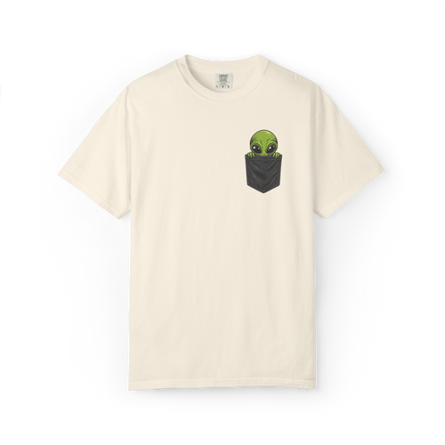 Ivory alien shirt featuring a green alien peeking out of a black pocket graphic