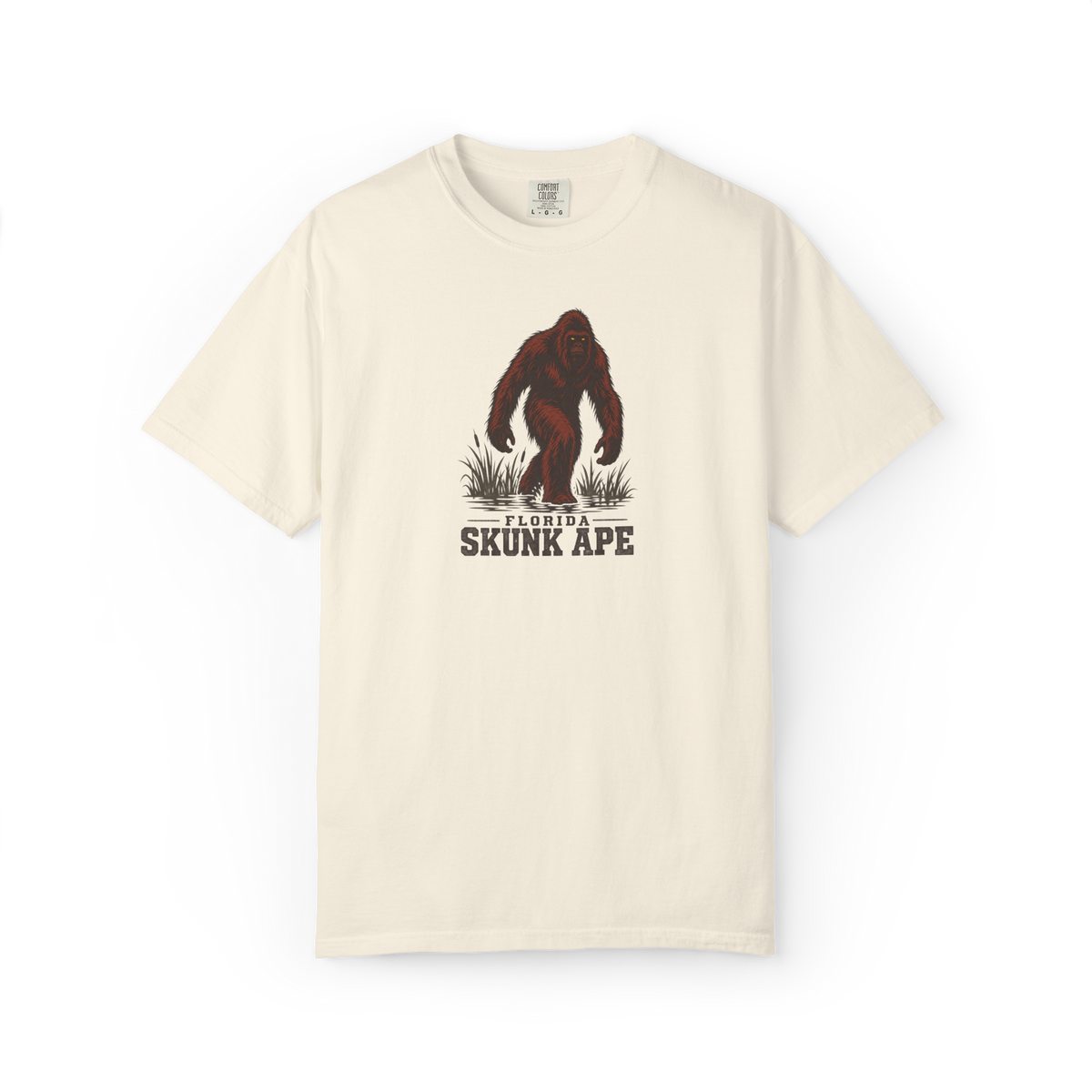 Ivory Florida Skunk Ape t shirt with a full-body dark red-brown skunk ape walking through swamp grass above Florida Skunk Ape text
