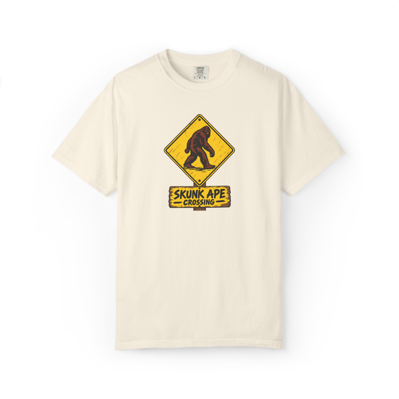 Ivory Skunk Ape t shirt with yellow Skunk Ape Crossing warning sign featuring a dark red-brown walking cryptid