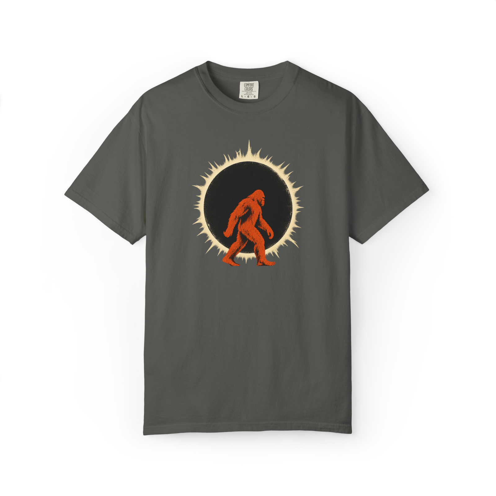 Dark gray Bigfoot shirt featuring an orange Sasquatch silhouette walking in front of a black solar eclipse with a glowing cream ring