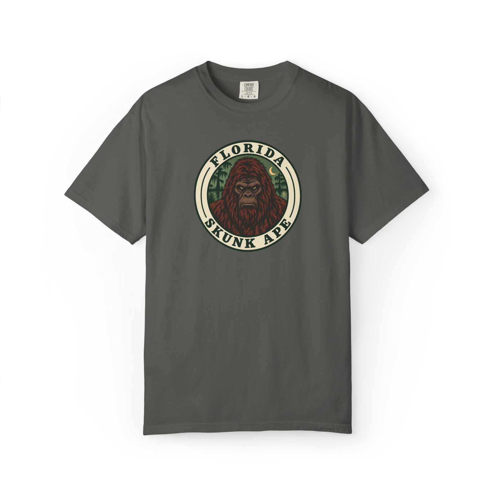 Dark gray Florida Skunk Ape t shirt with circular badge design showing a red-brown skunk ape portrait and swamp background