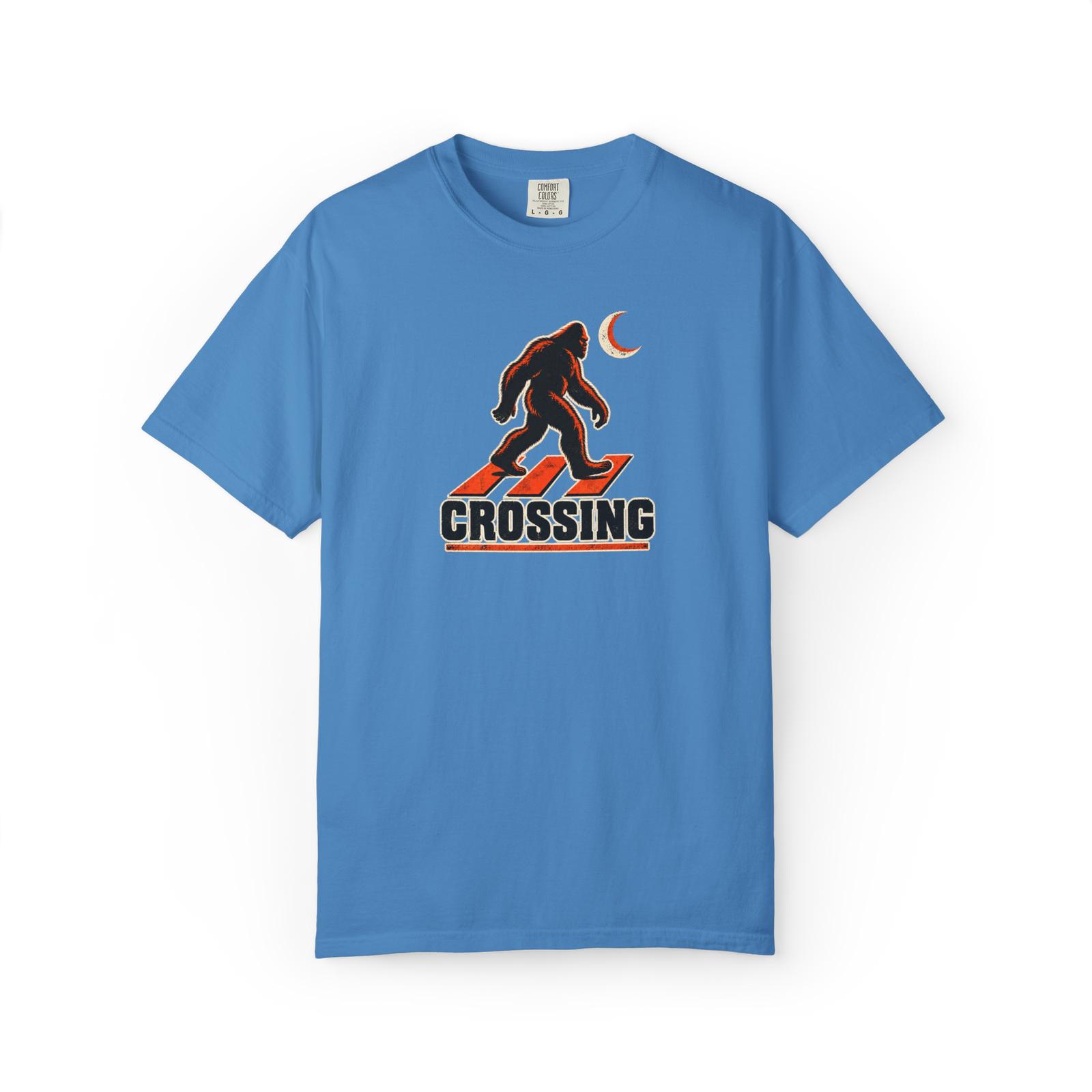 Blue Bigfoot t shirt with walking Sasquatch over a red crosswalk graphic, crescent moon, and Crossing text
