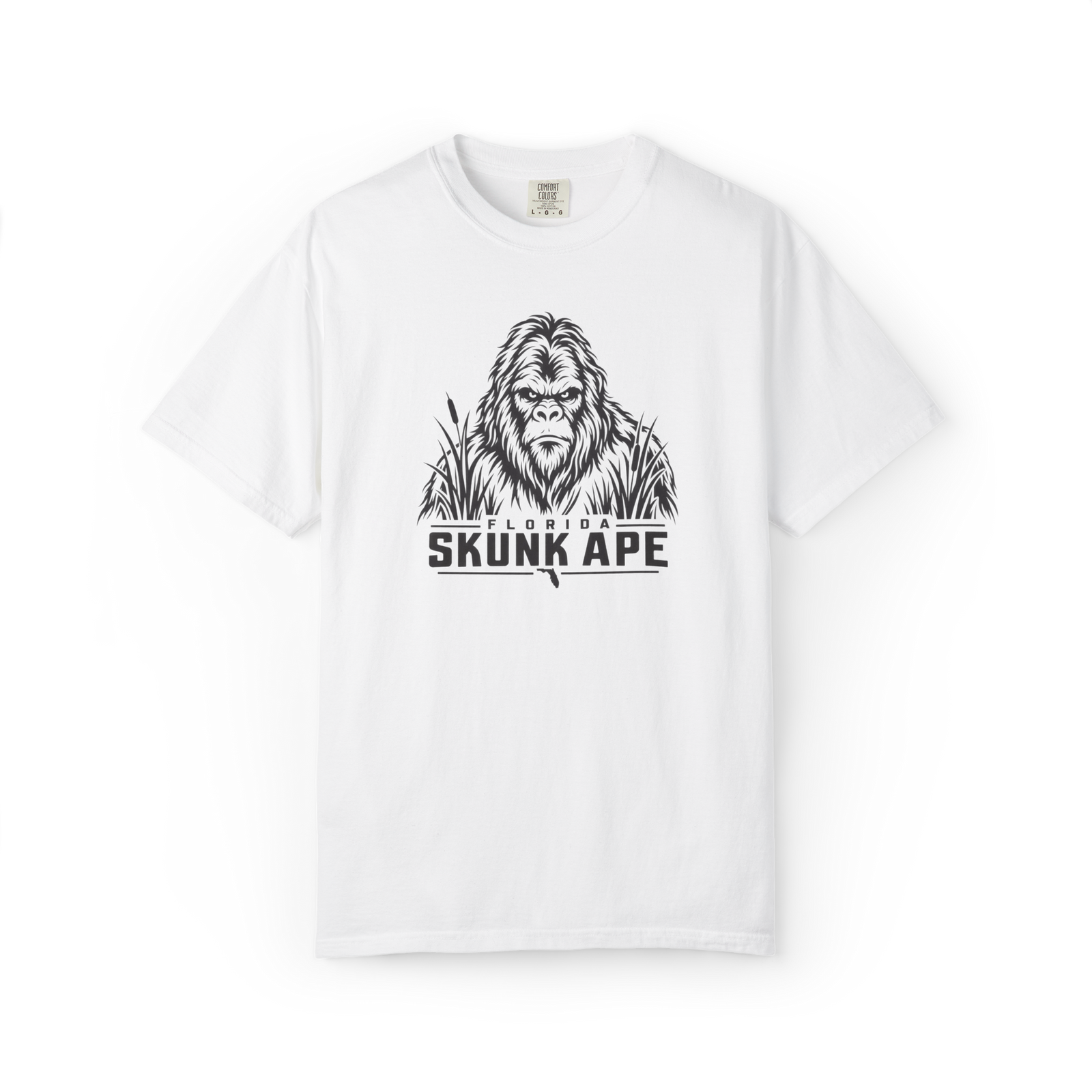 White Florida Skunk Ape t shirt with black cryptid face graphic, swamp grass, and Florida Skunk Ape text