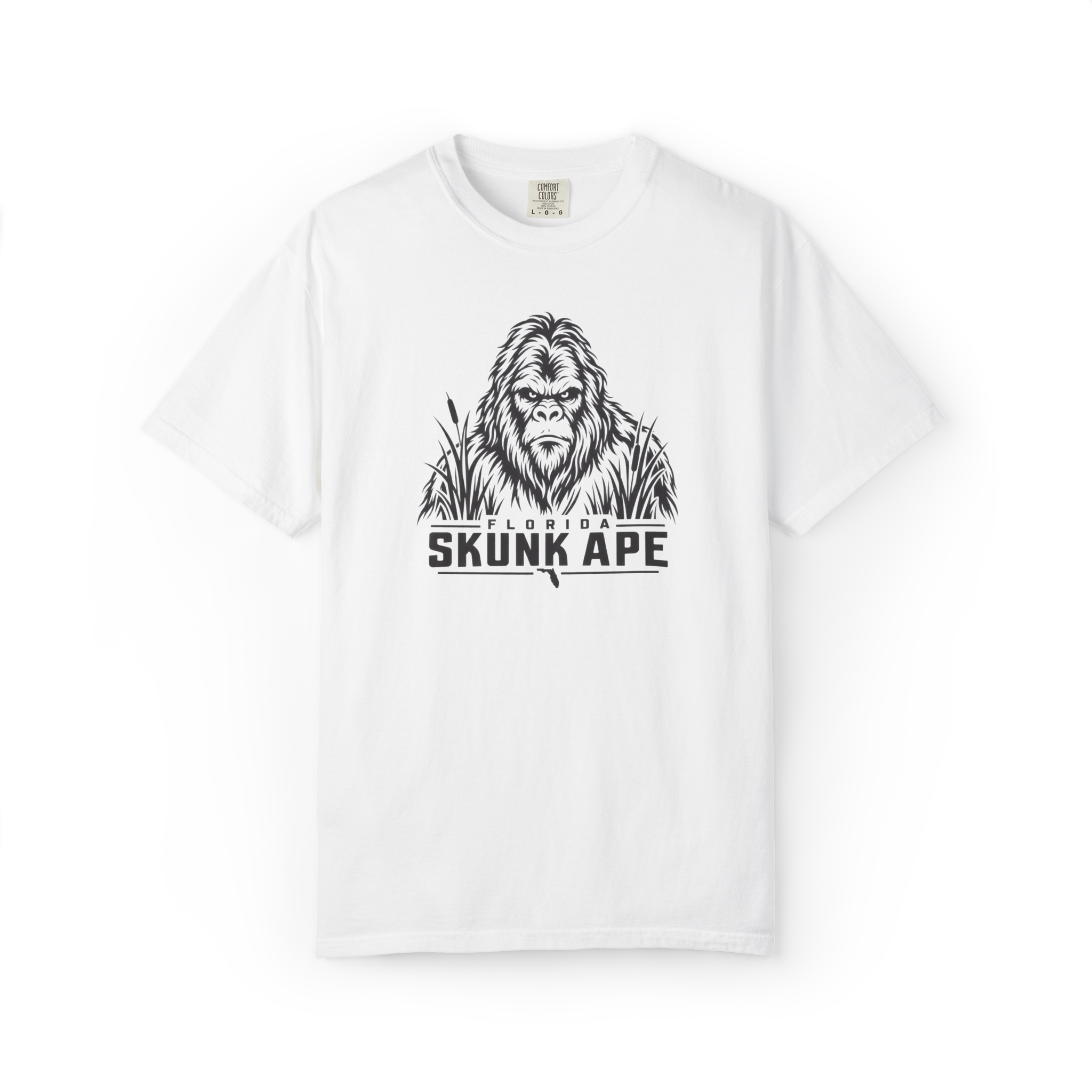 White Florida Skunk Ape t shirt with black cryptid face graphic, swamp grass, and Florida Skunk Ape text