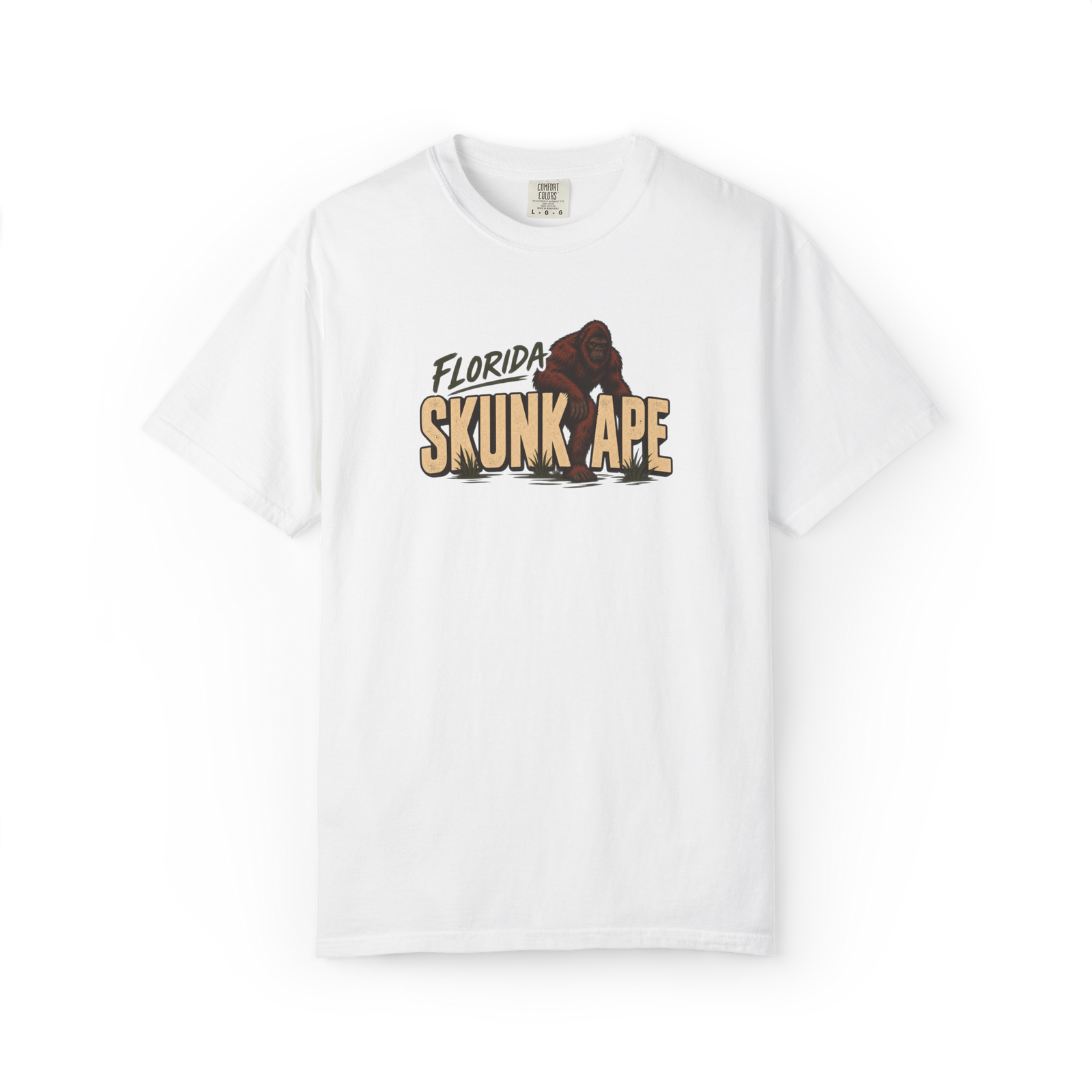White Florida Skunk Ape t shirt with bold tan text and a dark red-brown skunk ape walking through the design