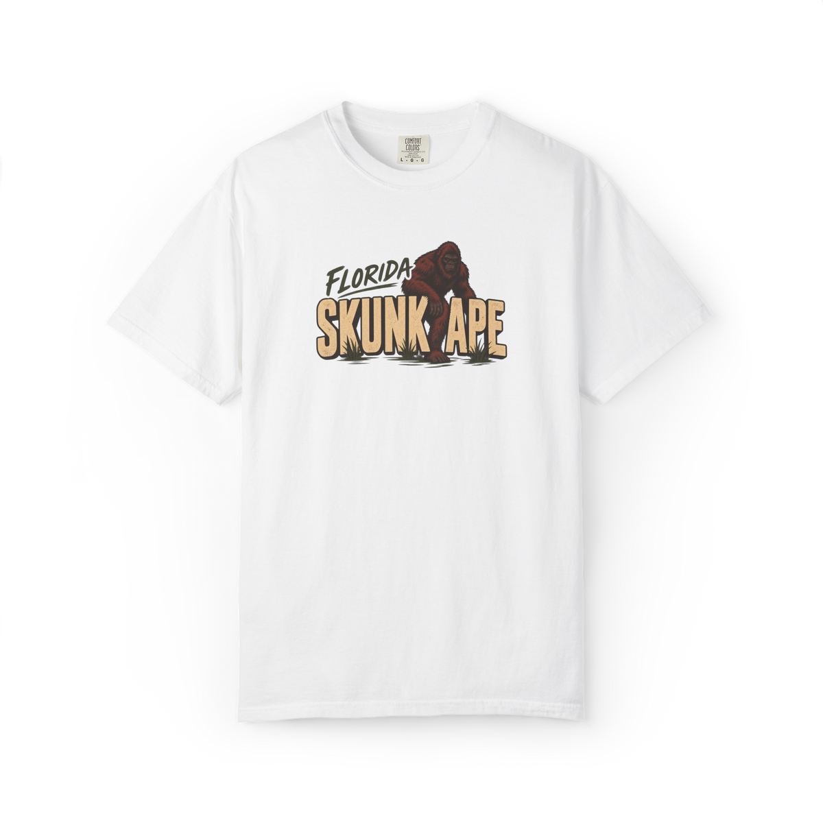White Florida Skunk Ape t shirt with bold tan text and a dark red-brown skunk ape walking through the design