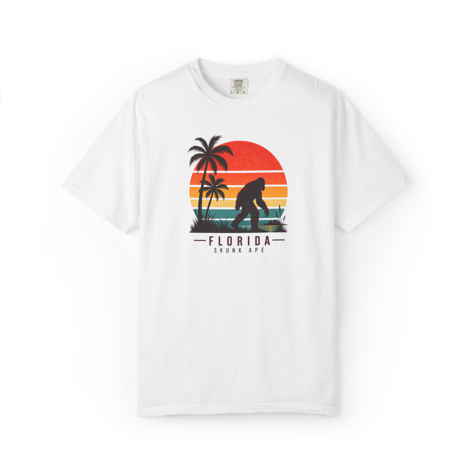 White Florida Skunk Ape t shirt with a retro sunset, palm trees, and walking skunk ape silhouette above Florida Skunk Ape text