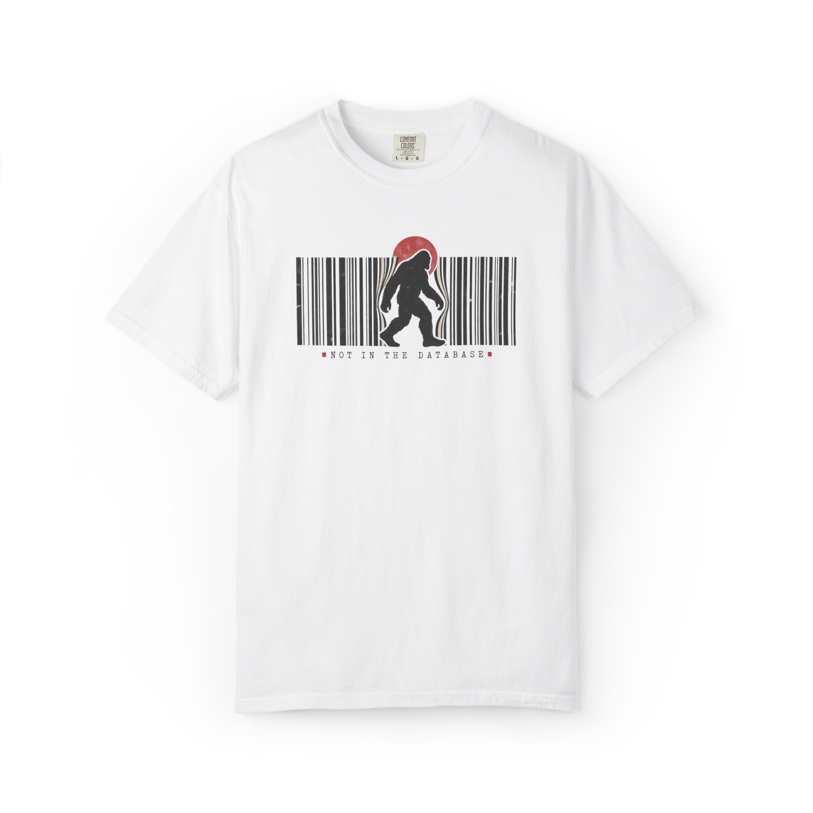 White Bigfoot t shirt with walking Sasquatch silhouette breaking through a black barcode, red sun, and Not in the Database text