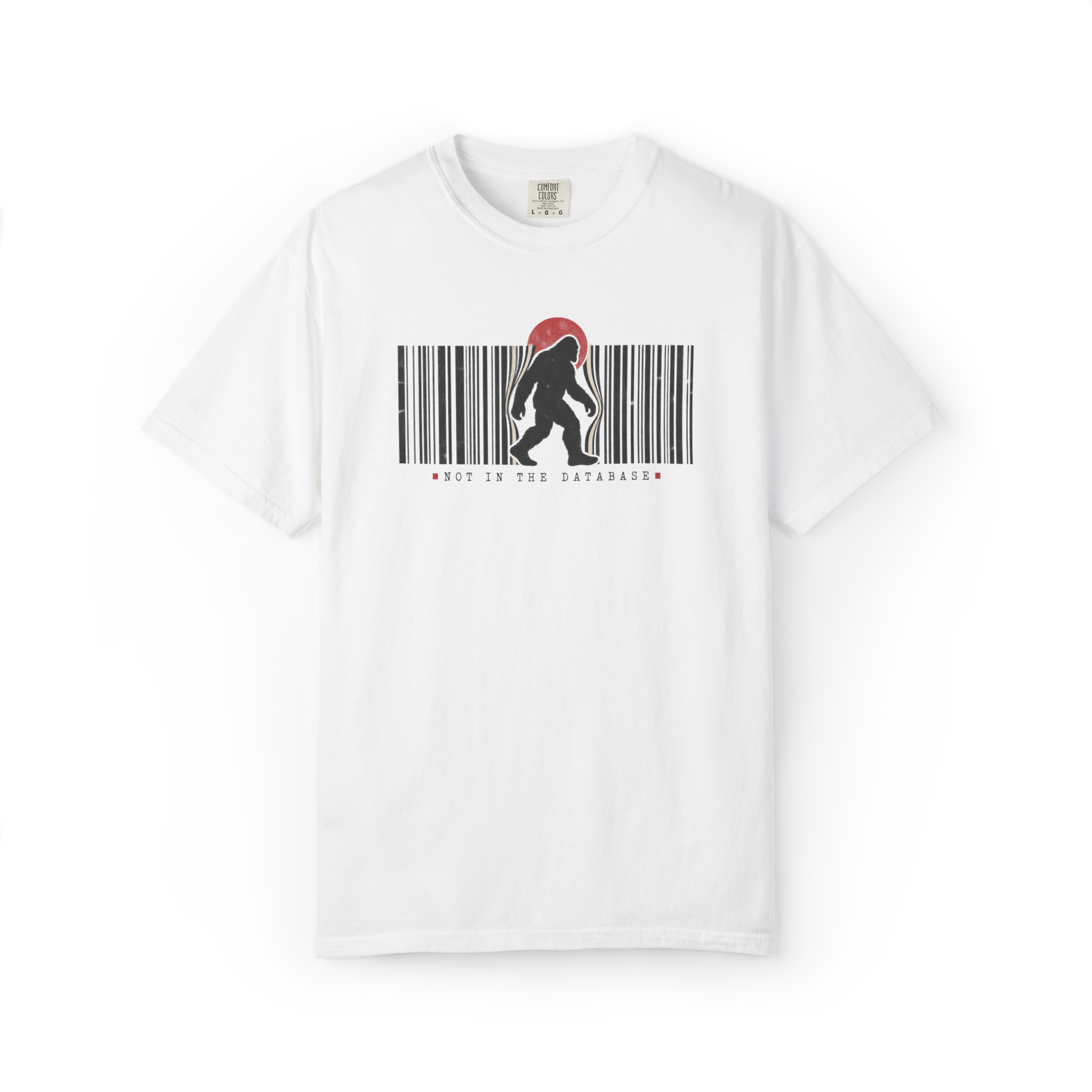 White Bigfoot t shirt with walking Sasquatch silhouette breaking through a black barcode, red sun, and Not in the Database text