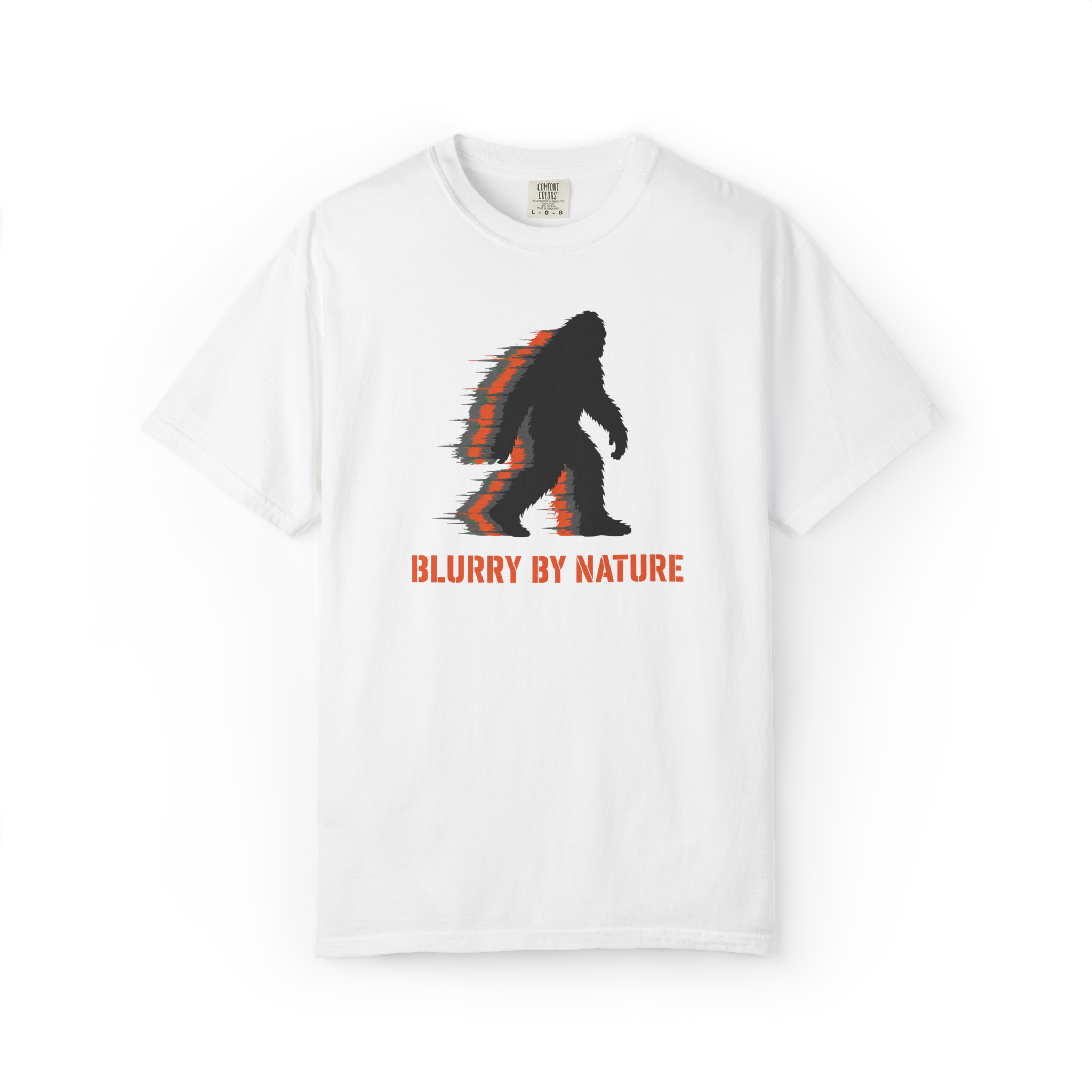 White Bigfoot t shirt featuring a black and orange blurred Sasquatch silhouette with Blurry By Nature text