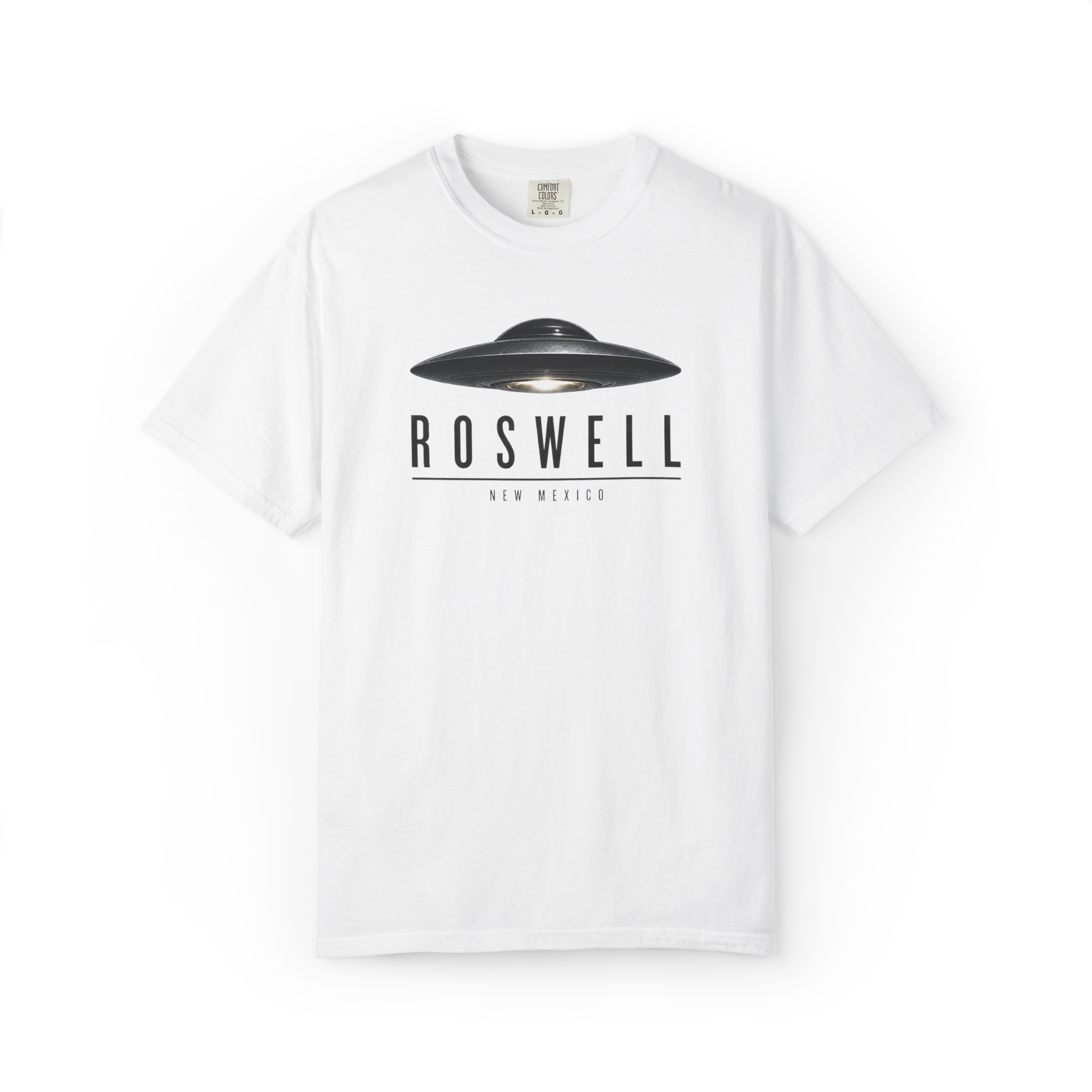 White Roswell UFO shirt featuring a black flying saucer above Roswell New Mexico text