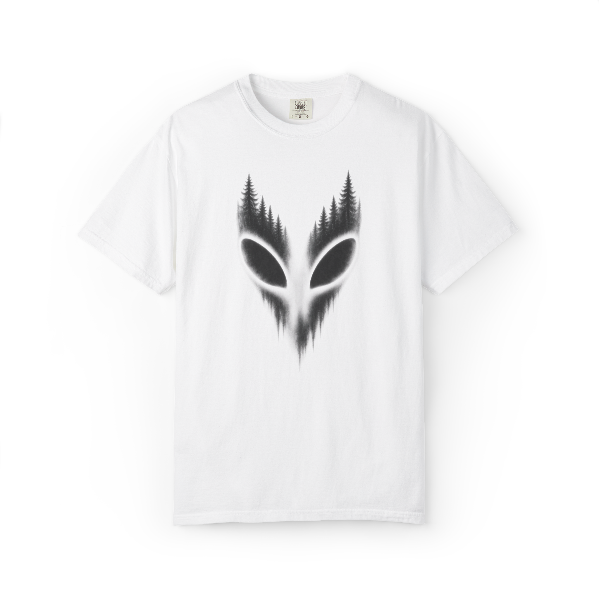 White alien shirt featuring black extraterrestrial eyes formed inside a dark pine forest silhouette